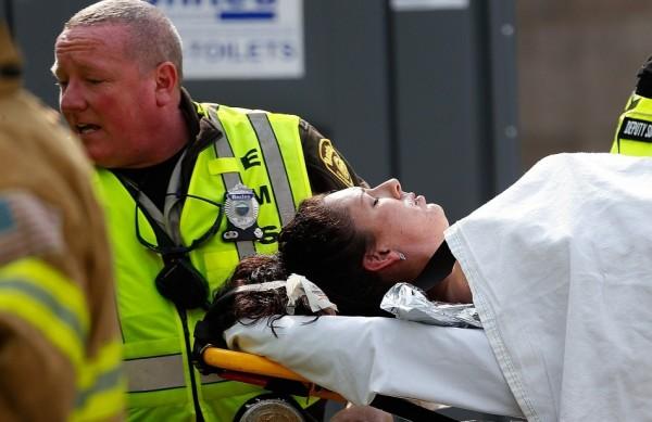 Equipe de resgate socorre vítimas das explosões na maratonad e Bostan (France Press)