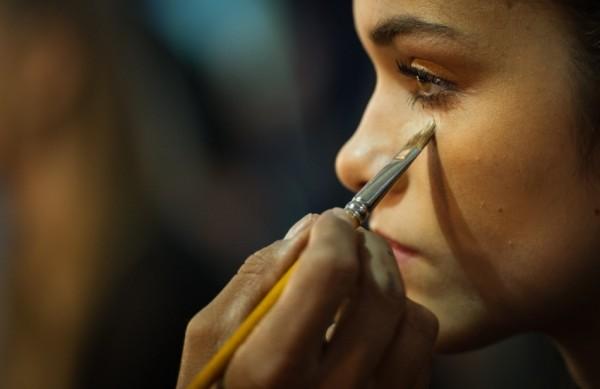 Modelo é maquiada antes de desfile no São Paulo Fashion Week 2013/2014 (France Presse)