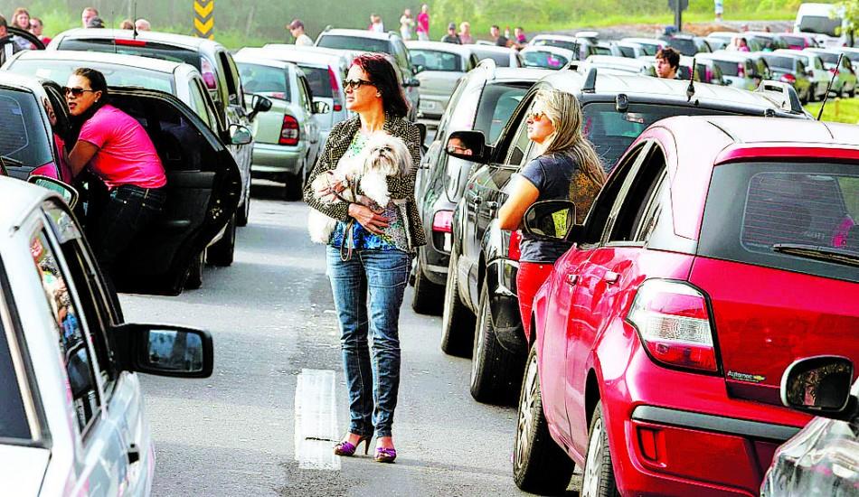 Mulher sai do carro para passear com o cachorro em raz&atilde;o do tr&acirc;nsito parado da Rodovia dos Tamoios ( Cedoc/RAC)