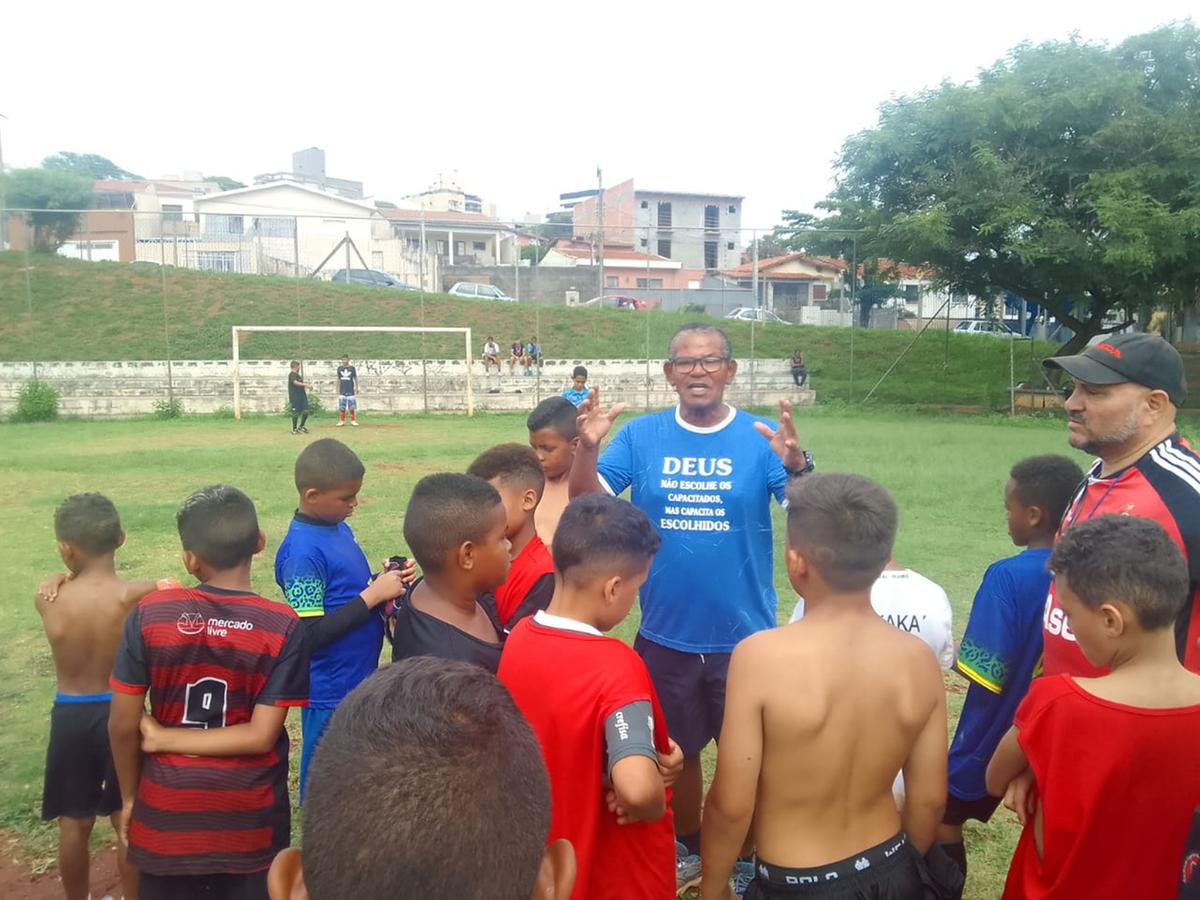 Carlos Quirino conversa com com seus alunos em momento de descontração; prioridade é a escola (Divulgação)