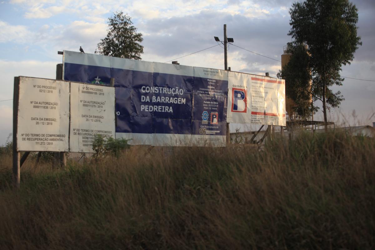Placa fixada em março de 2018 informa que a Barragem Pedreira seria concluída em 61 meses: superado o prazo, as obras estão atrasadas e as máquinas paradas, em virtude da extinção dos contratos com as empreiteiras (Kamá Ribeiro)