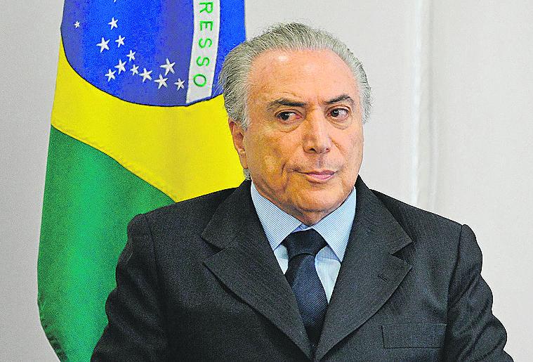 O presidente Michel Temer garantiu que vai acabar com a diferença entre previdência geral e a de funcionários públicos sem dar detalhes  (Andressa Anholete/AFP)