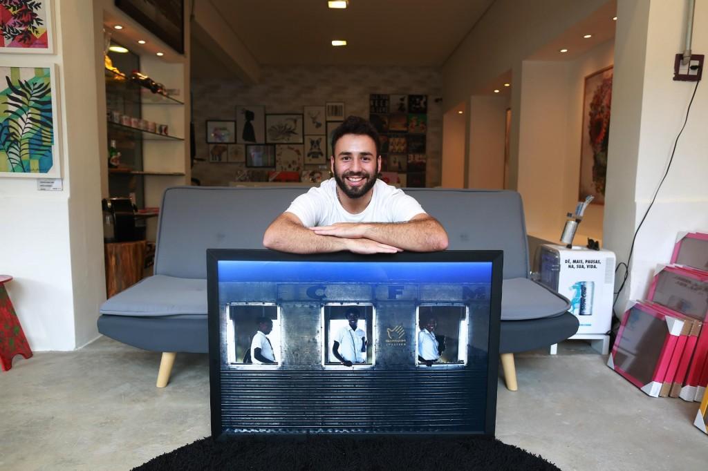 Andr&eacute; Montejano posa com uma das fotos que integram a exposi&ccedil;&atilde;o ( Leandro Ferreira/ AAN)