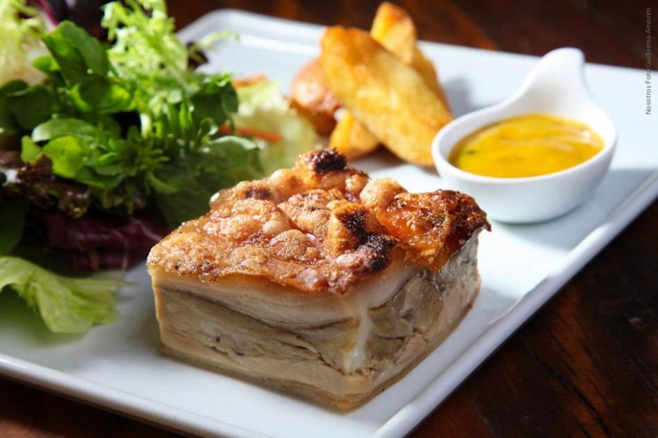 Nosotros: Cochinillo assado com batatas coradas, folhas verdes e molho mostarda (principal jantar)r
 ( Divulgação)