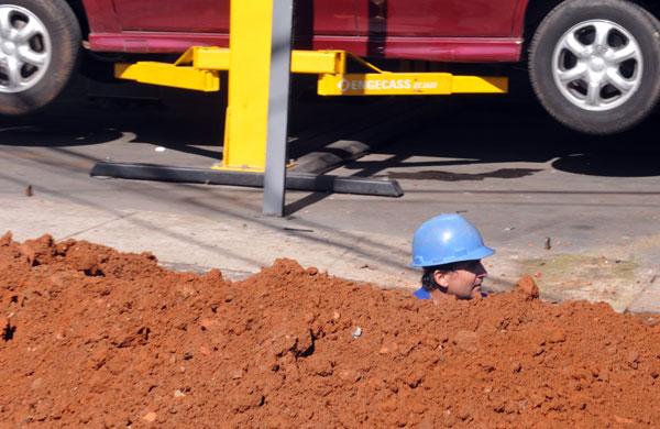 Homem em buraco exercendo sua função de trabalho (Dominique Torquato/AAN)